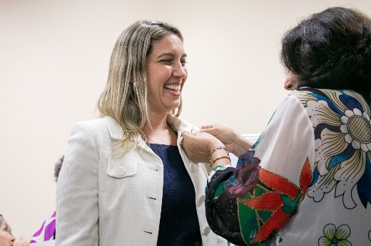 A deputada Larissa Gaspar recebe o broche de associada da ABMCJ, após o juramento realizado na cerimônia (Foto: Ribamar Neto/UFC) Deputada Larissa Gaspar tem fixado em sua blusa o broche de associada da ABMCJ