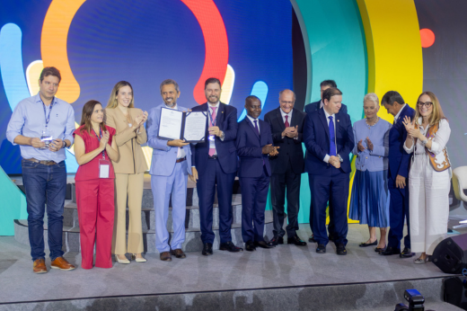 Ainda durante o evento, o governador Elmano de Freitas sancionou uma lei estadual que banirá alimentos ultraprocessados da alimentação ofertada pelas escolas cearenses até 2027 (Foto: Guilherme Silva / UFC Informa) Imagem: Foto do governador Elmano de Freitas segurando a lei sobre alimentação escolar sancionada por ele