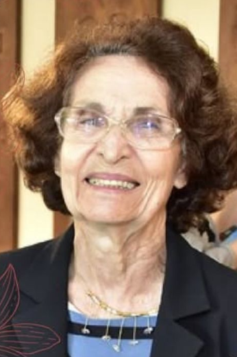 Em mais de 60 anos de atuação profissional, Maria Zélia Rouquayrol deixou um legado fundamental para a área da saúde coletiva no País (Foto: acervo pessoal) Imagem: uma mulher idosa, de óculos e cabelos castanhos ondulados, na altura do queixo, sorri para a câmera. Ela veste um blazer azul escuro e uma blusa azul clara